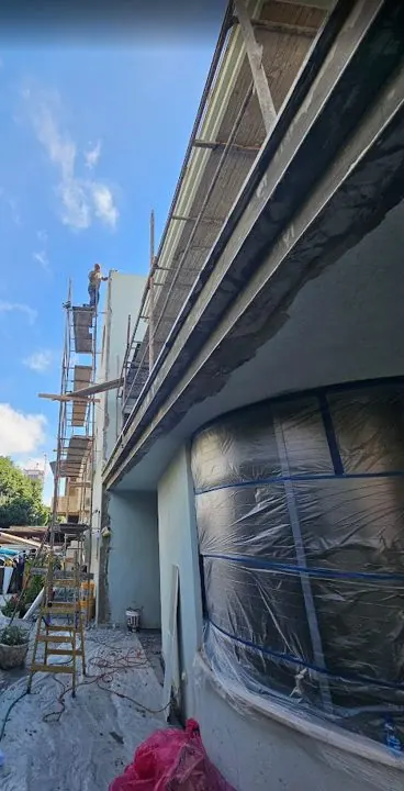 Échafaudages et fenêtre bâchée pendant les travaux de façade